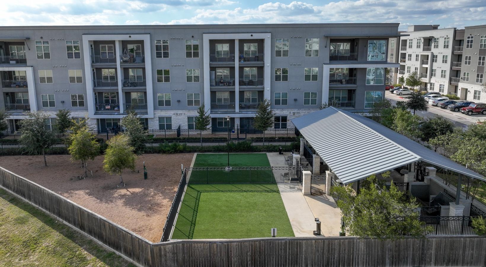 We're a pet-friendly community a building with a green lawn