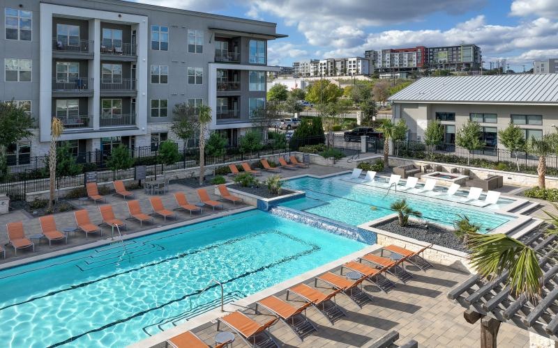 a swimming pool with chairs around it