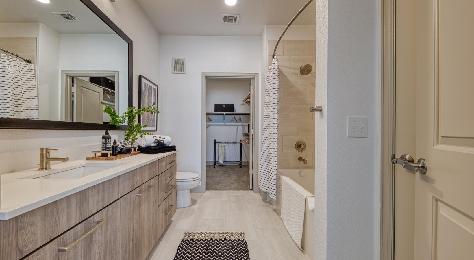 Spacious bathrooms with everything you need a bathroom with a tub sink and a toilet
