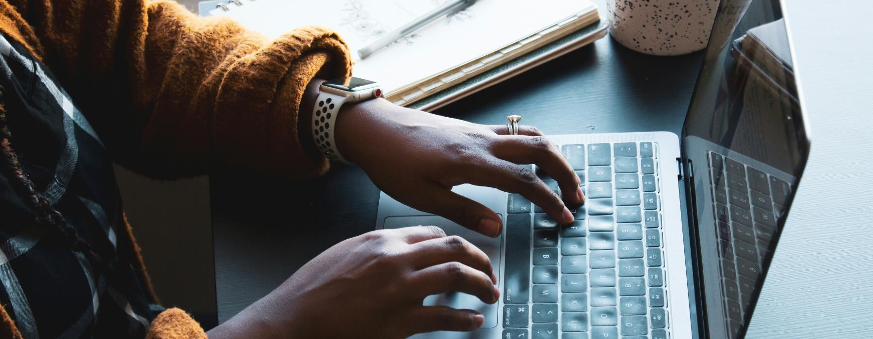 a person typing on a laptop