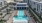 a pool in a courtyard between buildings