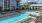 a swimming pool with chairs around it